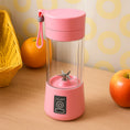 Pink portable blender on a wooden surface with fruits in the background
Portable USB Electric Juicer