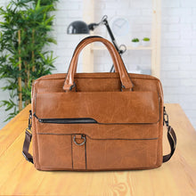 Brown leather briefcase on a wooden surface with a plant and lamp in the background