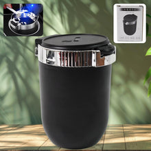 Black car ashtray with chrome accents on a wooden surface with greenery in the background