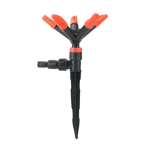 Garden irrigation spike with red nozzles on a white background