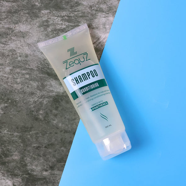 Tube of Zequz shampoo on a gray and blue gradient background