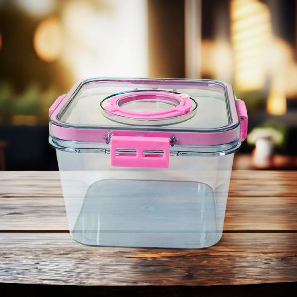 Clear food storage container with pink lid on a wooden surface