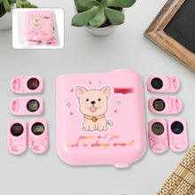 Pink pet training device set with cartoon dog design on a light gray surface.
