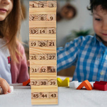 Children playing with a tall stack of wooden blocks with numbers on them.