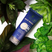 Blue face wash tube with green leaves in the background