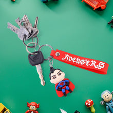 Keychain with superhero figure and 'Avengers' tag on a green background