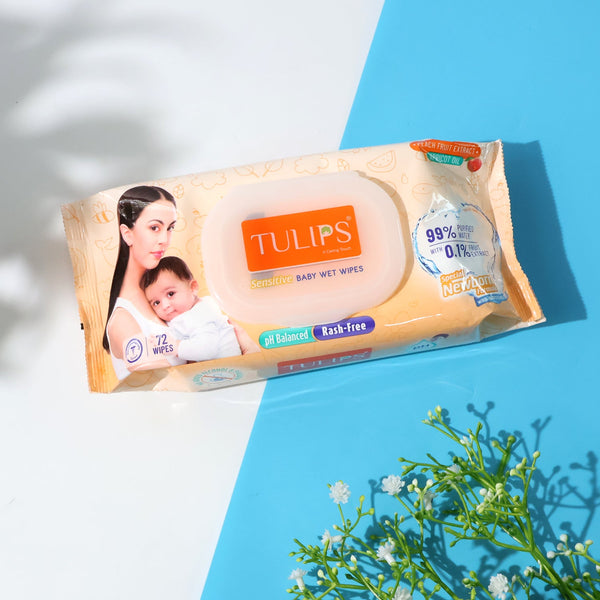 Tulips baby wet wipes packaging on a blue surface with a white background