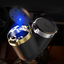 Black and gold ring box with blue light inside, held by a hand.