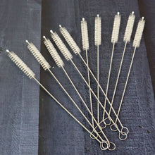 Set of straw cleaning brushes on a dark textured surface