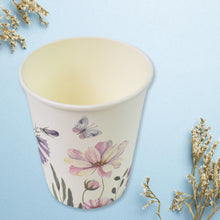 Ceramic cup with floral design on a light blue background