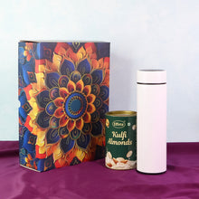 Colorful decorative box, green canister labeled 'Kulfi Almonds', and white thermos on a purple surface.