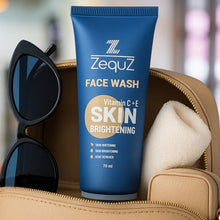 Zequz face wash tube with sunglasses and a towel on a blurred background