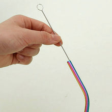 Hand holding a colorful metal straw against a plain background