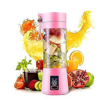Pink portable blender with fruits and a glass of juice on a white background