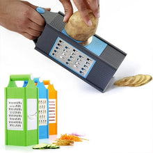 Hand using a multi-tool grater to slice a potato with additional grating tools and sliced vegetables displayed.