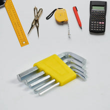 Set of hex keys on a white surface with a ruler, scissors, tape measure, and calculator.