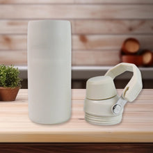 Two beige containers on a wooden surface with a blurred background