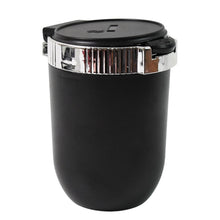 Black travel mug with a silver lid on a white background