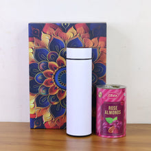 White tumbler with a colorful box and a can of Effete Rose Almonds on a wooden surface.