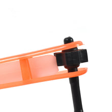 Close-up of an orange tool with a black handle on a white background