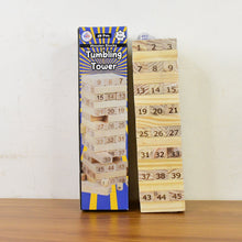 Wooden tumbling tower with packaging on a wooden surface