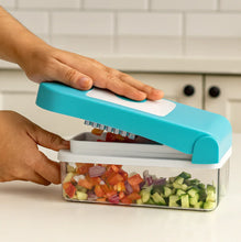 Hand using a blue vegetable chopper to chop vegetables in a kitchen setting