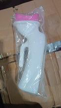 White spray bottle with pink nozzle on a cardboard surface