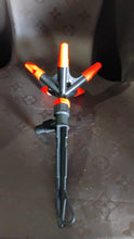 Garden pruner with orange accents on a textured surface