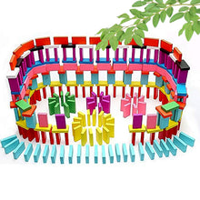 Colorful domino set with a white background and green leaves.