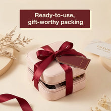 Stack of pink gift boxes with a red ribbon and tag on a beige background