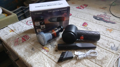 Portable vacuum cleaner with attachments on a tiled floor