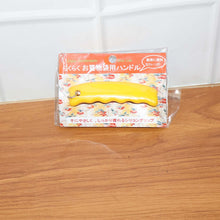 Yellow tool in packaging on a wooden surface