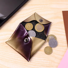 Coin purse with coins on a wooden surface