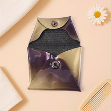 Metallic pouch with textured interior on a beige 
