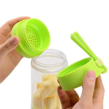 Green lid with a mesh top being placed onto a clear container filled with yellow fruit pieces.