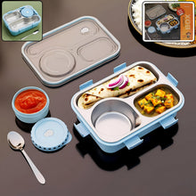 Blue and gray bento box with compartments containing food on a dark surface.