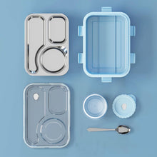 Set of stainless steel lunch containers and accessories on a blue background