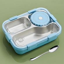 Blue and silver bento box with a spoon on a green background