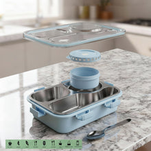 Stainless steel and blue plastic food container on a marble countertop with a spoon.