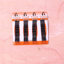Pack of black hair straighteners with 'Tina Beauty' branding on a pink background