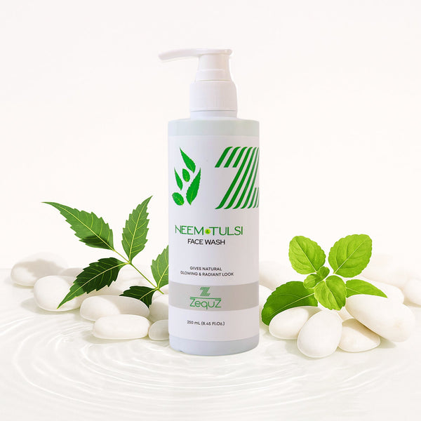 Neem Tulsi face wash bottle with green leaves and white stones on a white background