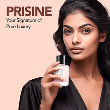 Woman holding a Prisine perfume bottle with the brand name displayed.