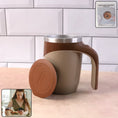 Brown mug with handle and brown lid on a surface with a tiled wall background