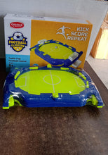 Tabletop football game with packaging on a wooden surface