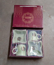 Packaged green mugs with a 'TESTO' brand box on a gray surface