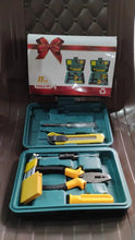 Tool set with tools and a toolbox on a wooden surface