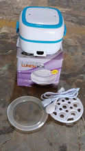 Electric lunch box with components on a stone surface