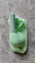 Green plastic tool on a textured gray surface